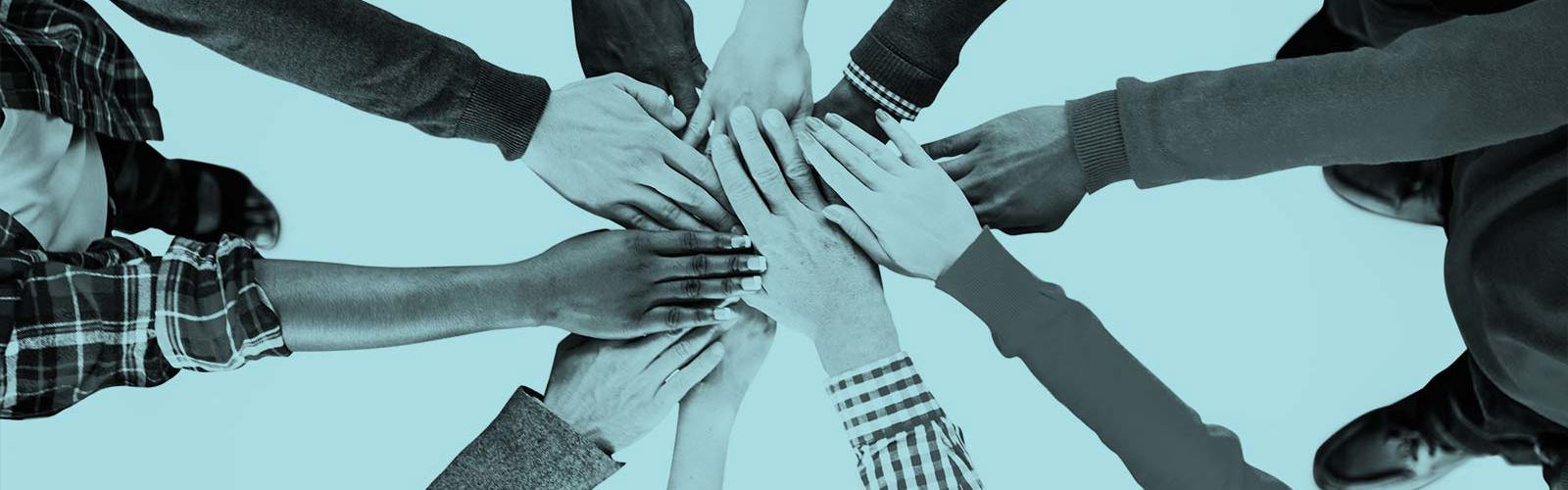 Group of hands coming together