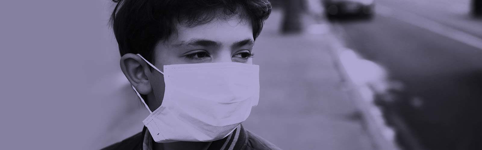 Boy wearing a surgical mask