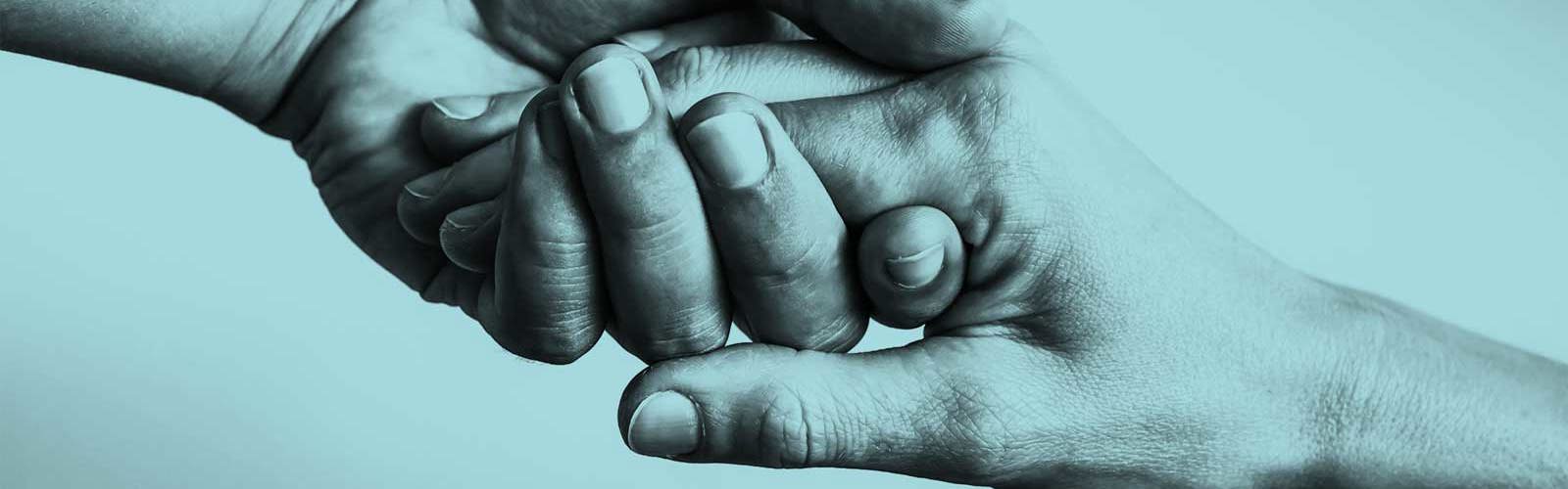 Two hands reaching out and holding