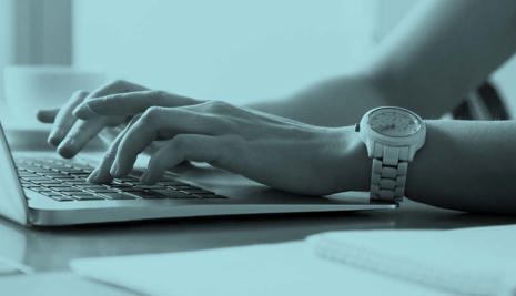 hands typing on a laptop