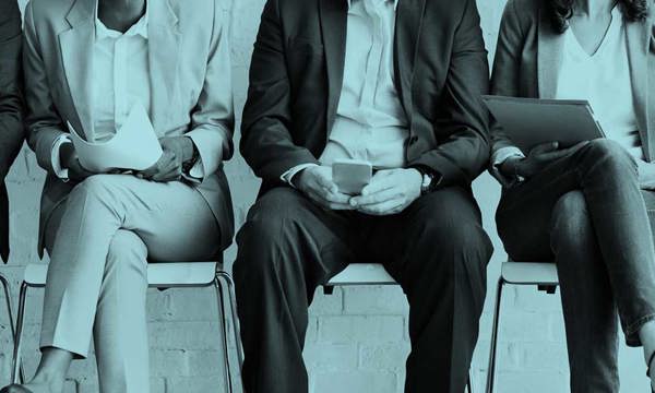 Row of people sitting in suits