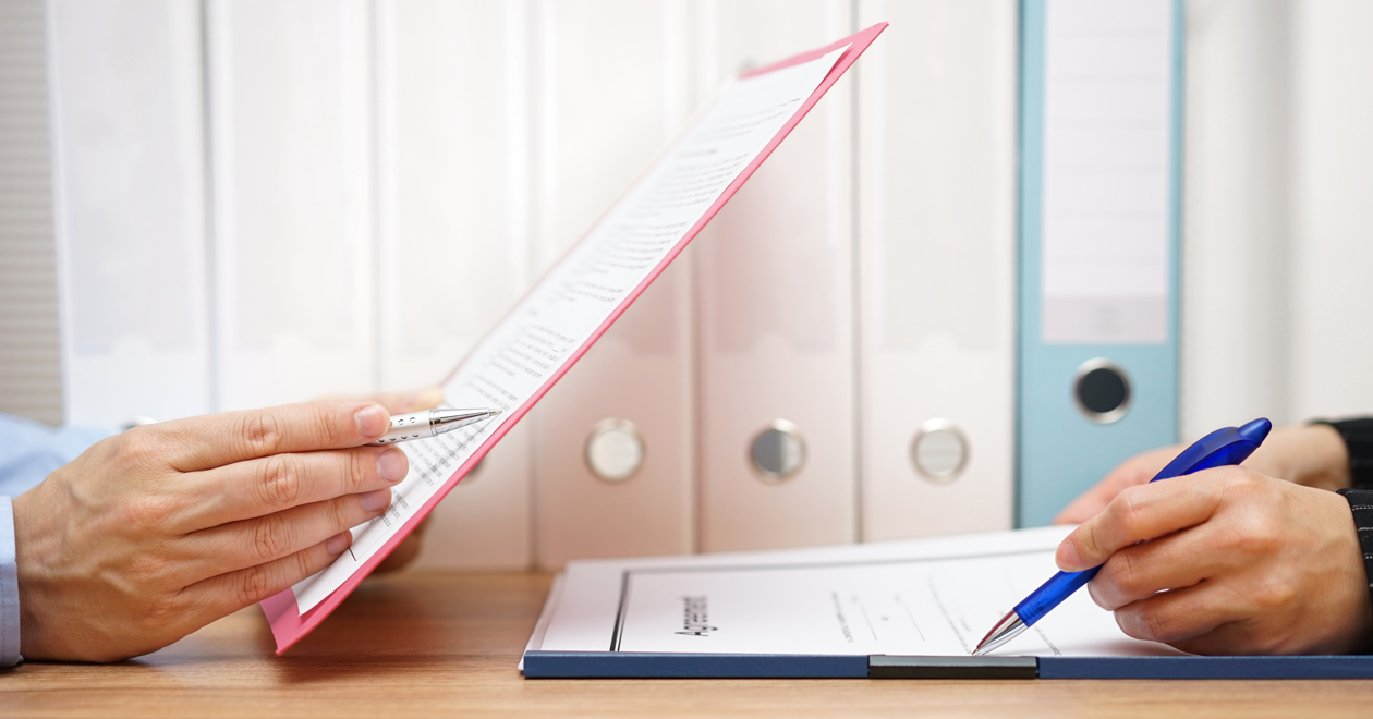 Two people inspecting documents