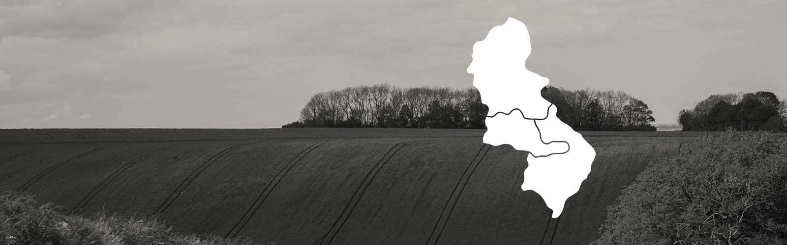 Photo of the countryside with a white map of West Midlands