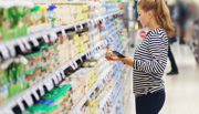 Woman reading ingredients label in supermarket