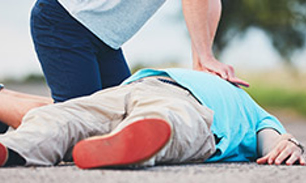 Two people, one giving and one receiving CPR