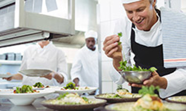 Person preparing food in a professional kitchen