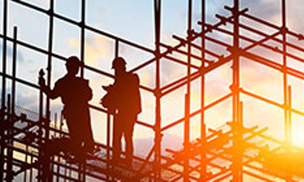 Two people at a building site