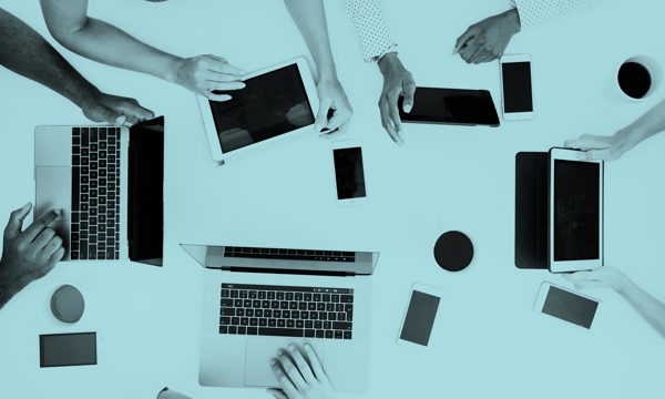 Many hands using different devices