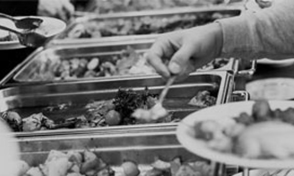 A close up of food in trays in a canteen