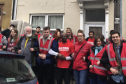 Housing campaigners in high-vis, standing in a line