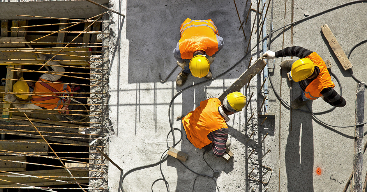 Three construction workers seen from above