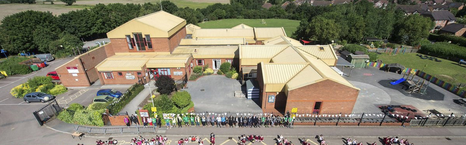 Aerial shot of schoolchildren standing together to form the words 'We love clean air'
