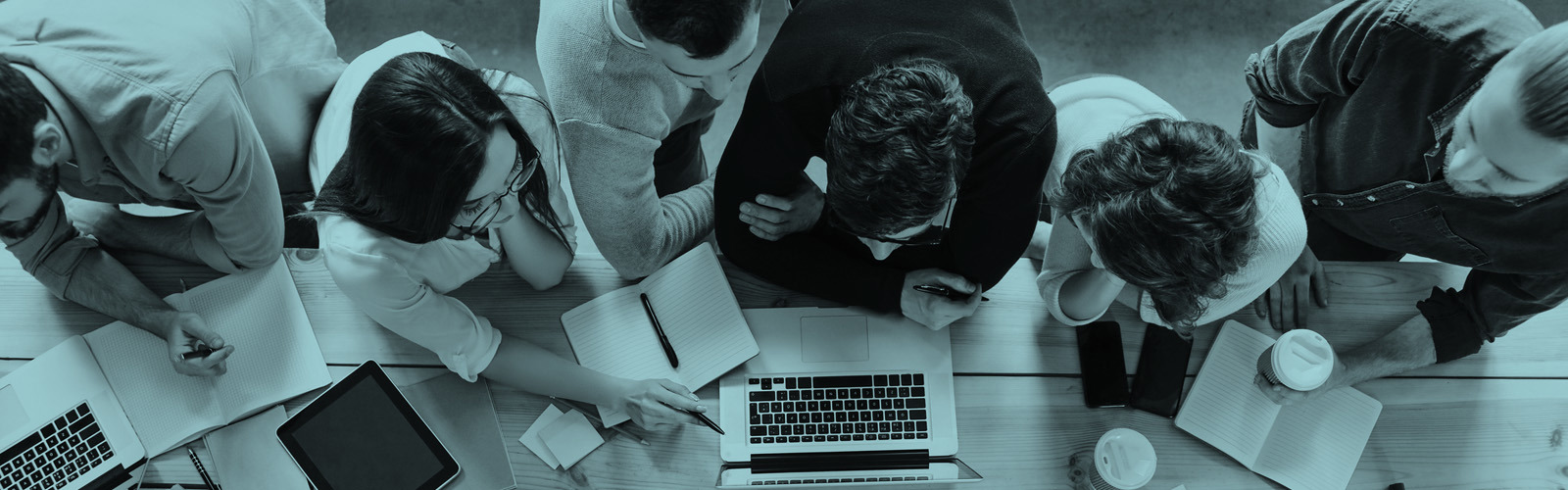 Top view of a group of people working on laptops