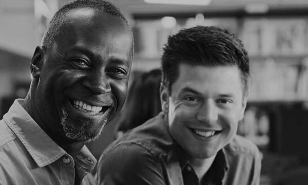 Two men smiling