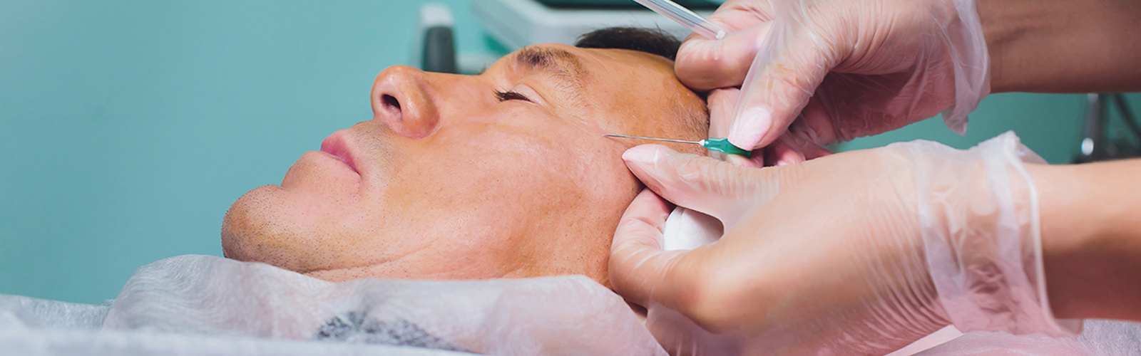 A person undergoing a cosmetic facial treatment