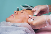 A person undergoing a cosmetic facial treatment