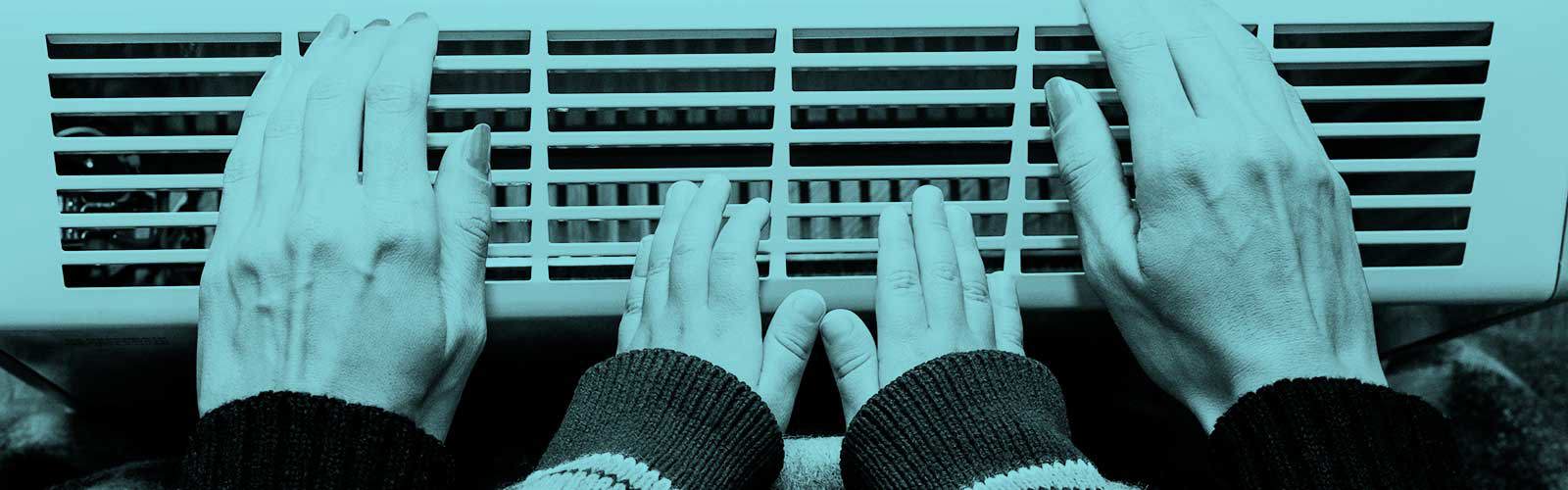 Hands on a radiator