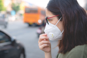 A woman wears a face mask.
