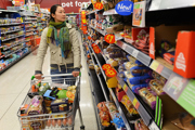 Woman pushes trolley in supermarket
