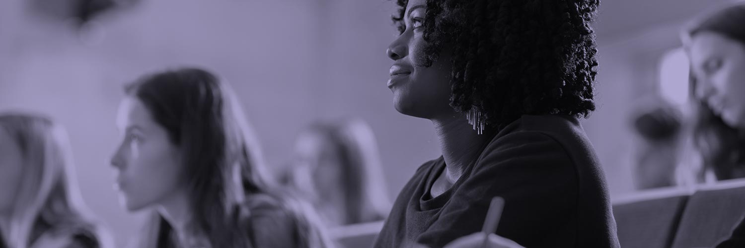 People listening attentively in a classroom setting