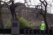 A protester at the 'Unknown building worker' statue in London