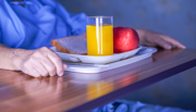 Hospital patient with orange juice and an apple