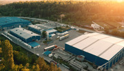 Industrial warehouses surrounded by trees