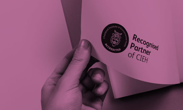 A hand turning the page of a book with the CIEH Recognised Partners logo printed in the bottom corner