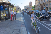 Woman riding bike on street with face mask
