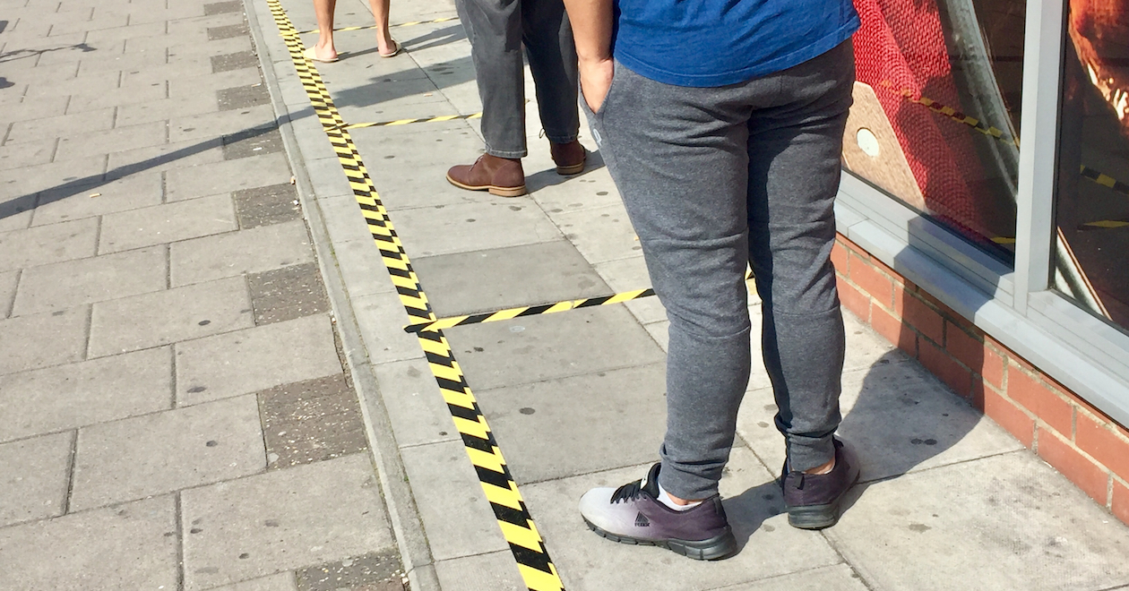 People in a queue with distance markers