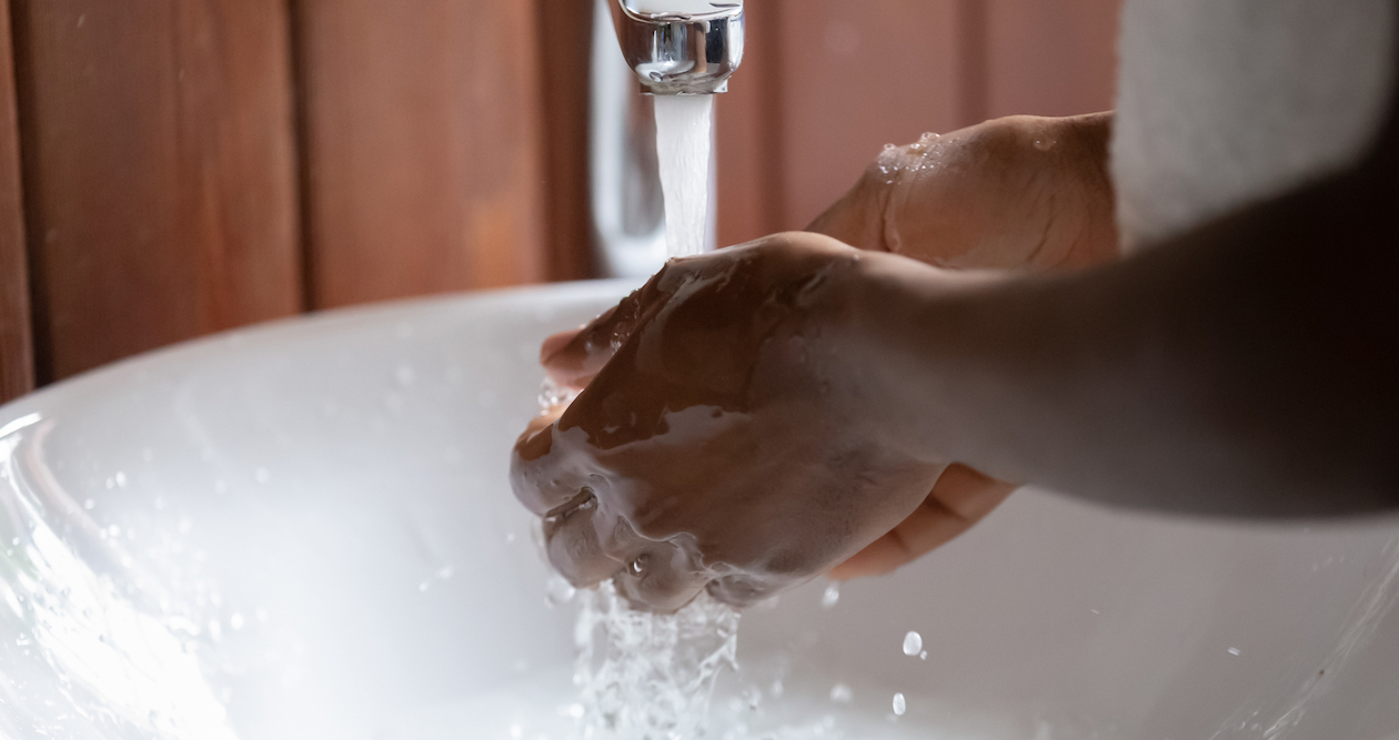 A woman's hands being washed in a sink