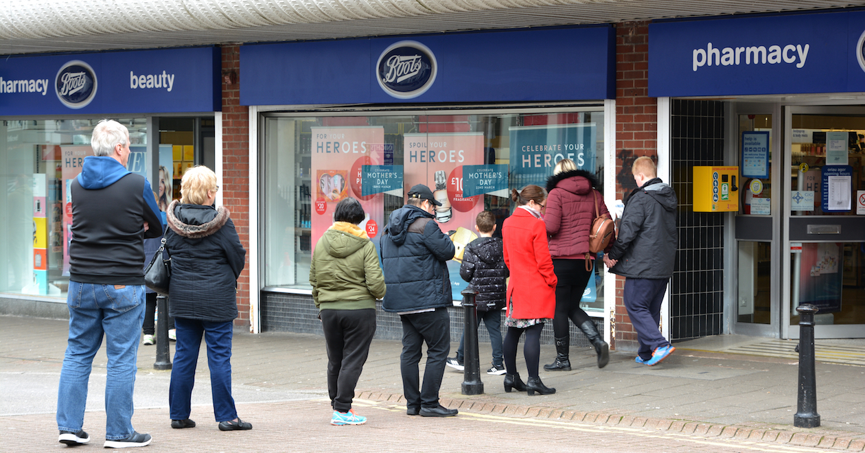 A queue of people outside a Boots
