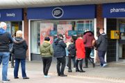 A queue of people outside a Boots