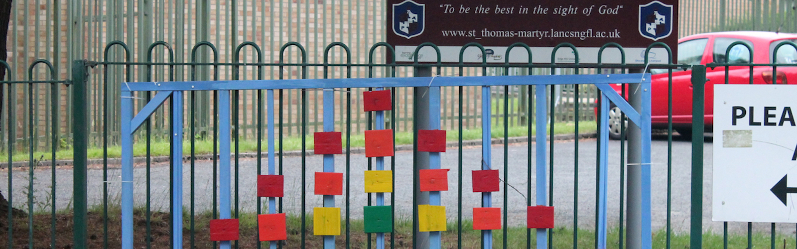 Up Holland, West Lancashire, UK: wooden rainbow blocks on a school gate in support of the NHS