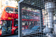 A London bus travelling past an air pollution monitor