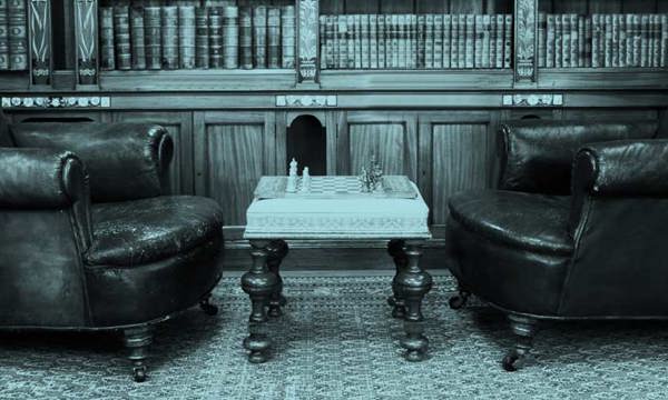 A reading room with two leather armchairs and a small coffee table