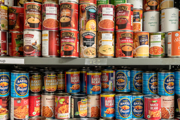 Tins of food sit on shelves in a food bacnk