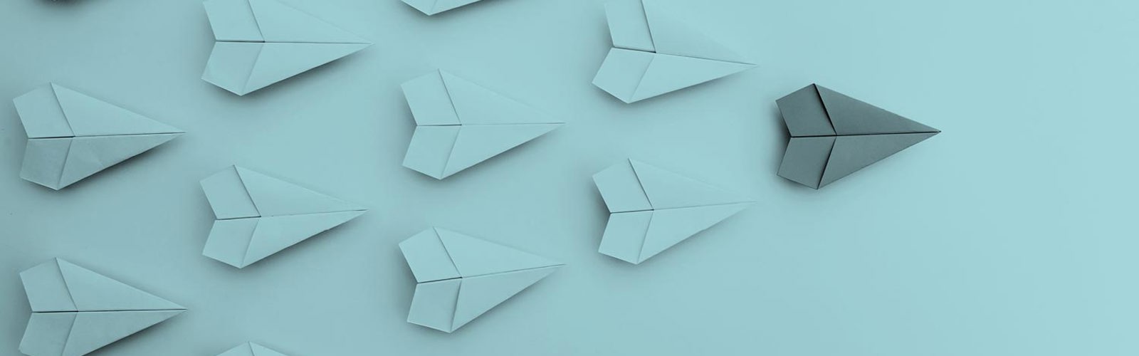Paper aeroplanes in a row