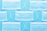 Face masks laid out on a blue background