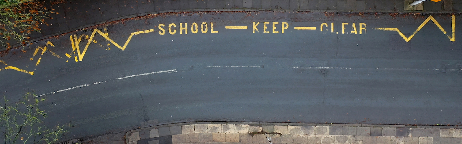 Aerial view of road markings saying 'school keep clear' 