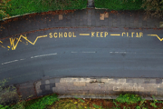 Aerial view of road markings saying 'school keep clear' 