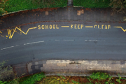 Aerial view of road markings saying 'school keep clear'