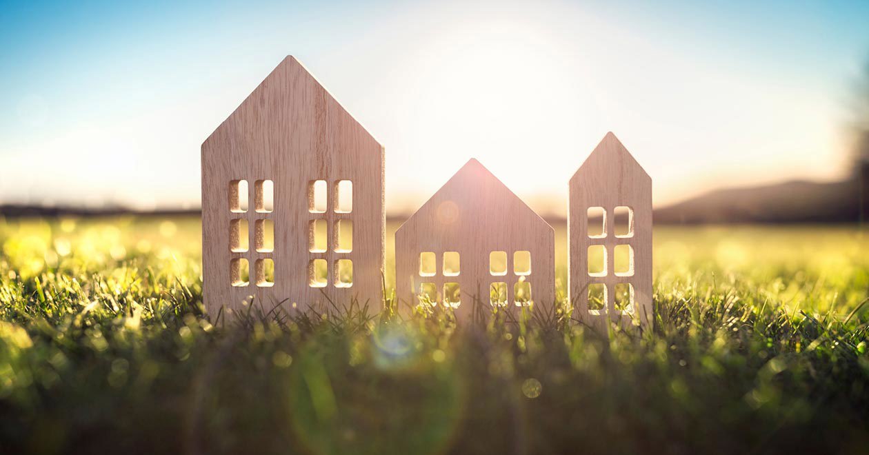 Wooden house cut out on grass on sunny day