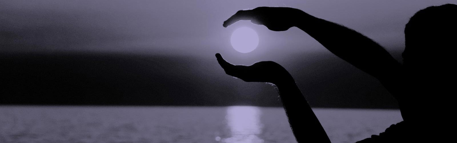 Person holding their hands around the sun