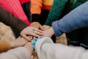 circle of hands resting on one another
