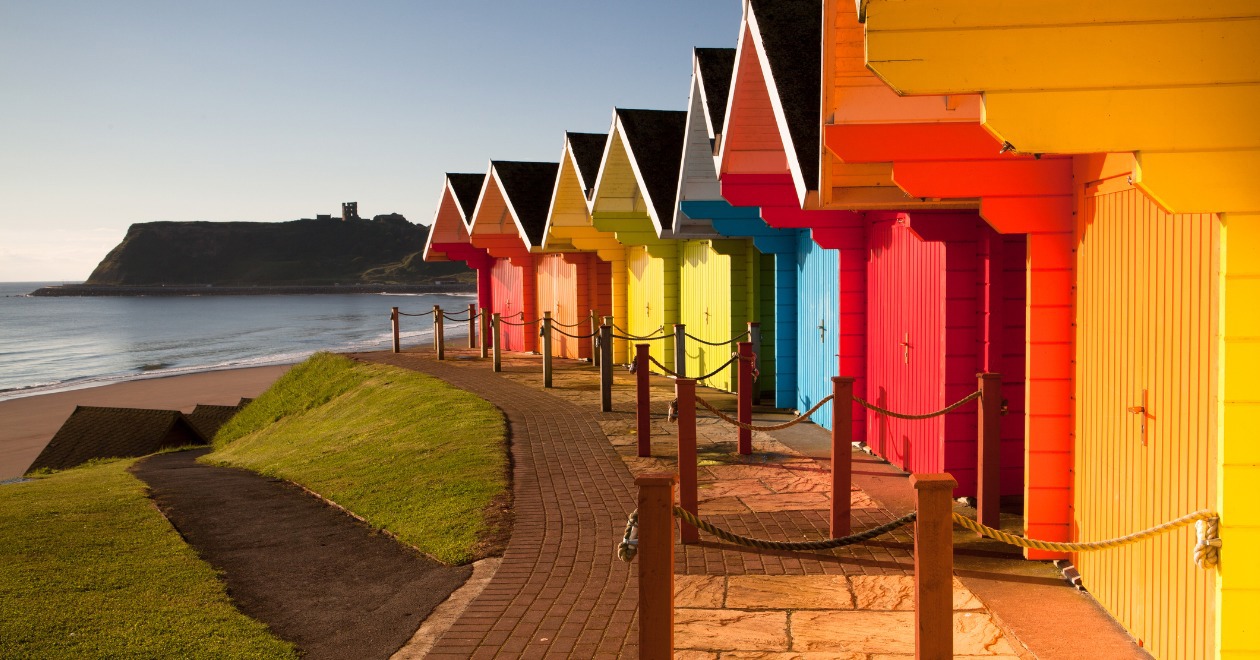 Row of multi colour beach huts by the coast