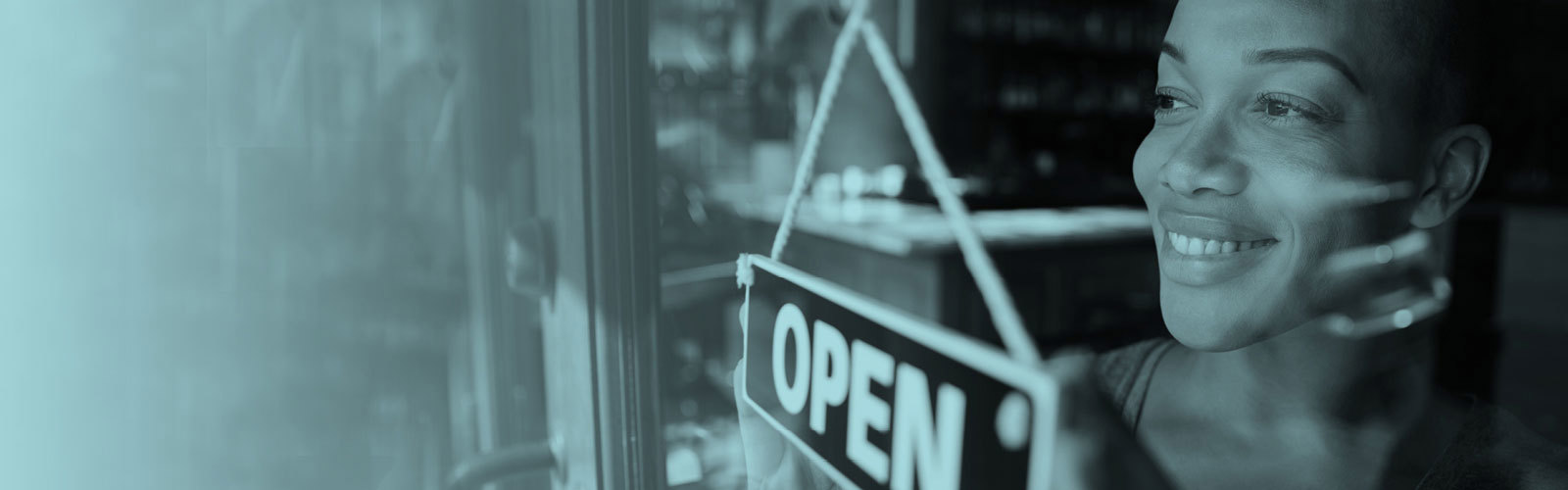 Woman putting an open sign on a door