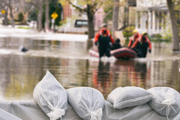 A boat transports people to dry land during flooding