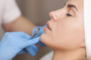 A woman receiving lip fillers