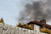 Smoke billowing from burning of mattresses